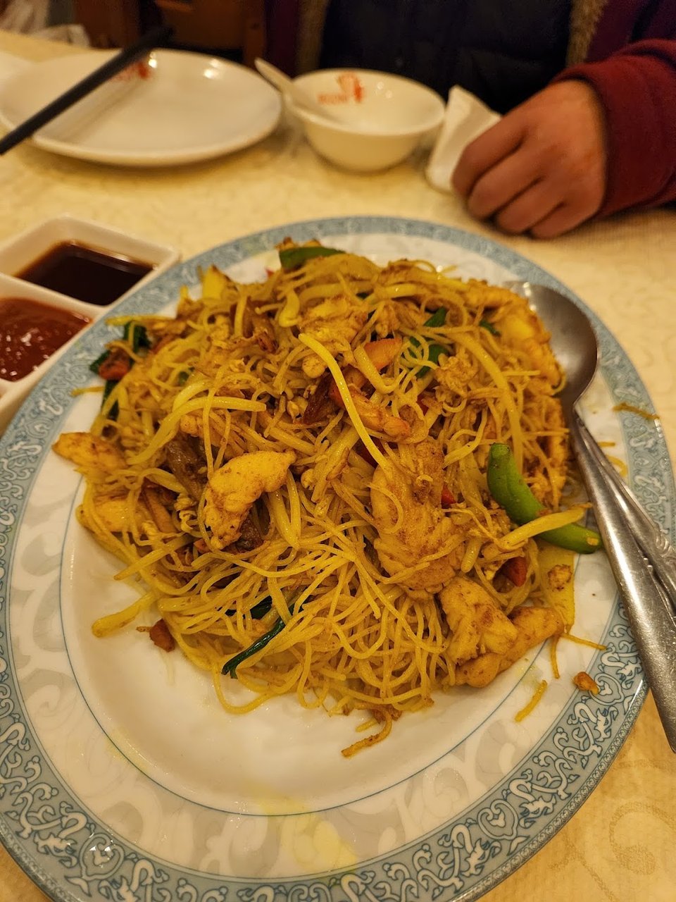 Printed menu featuring noodles, tofu, and steamed buns.